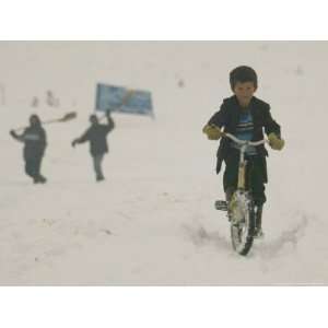  A Young Afghan Boy Rides His Bicycle on a Snow Covered 