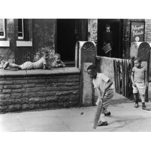  Young Black Boys Play Cricket on the Pavement in 