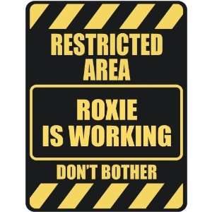   RESTRICTED AREA ROXIE IS WORKING  PARKING SIGN